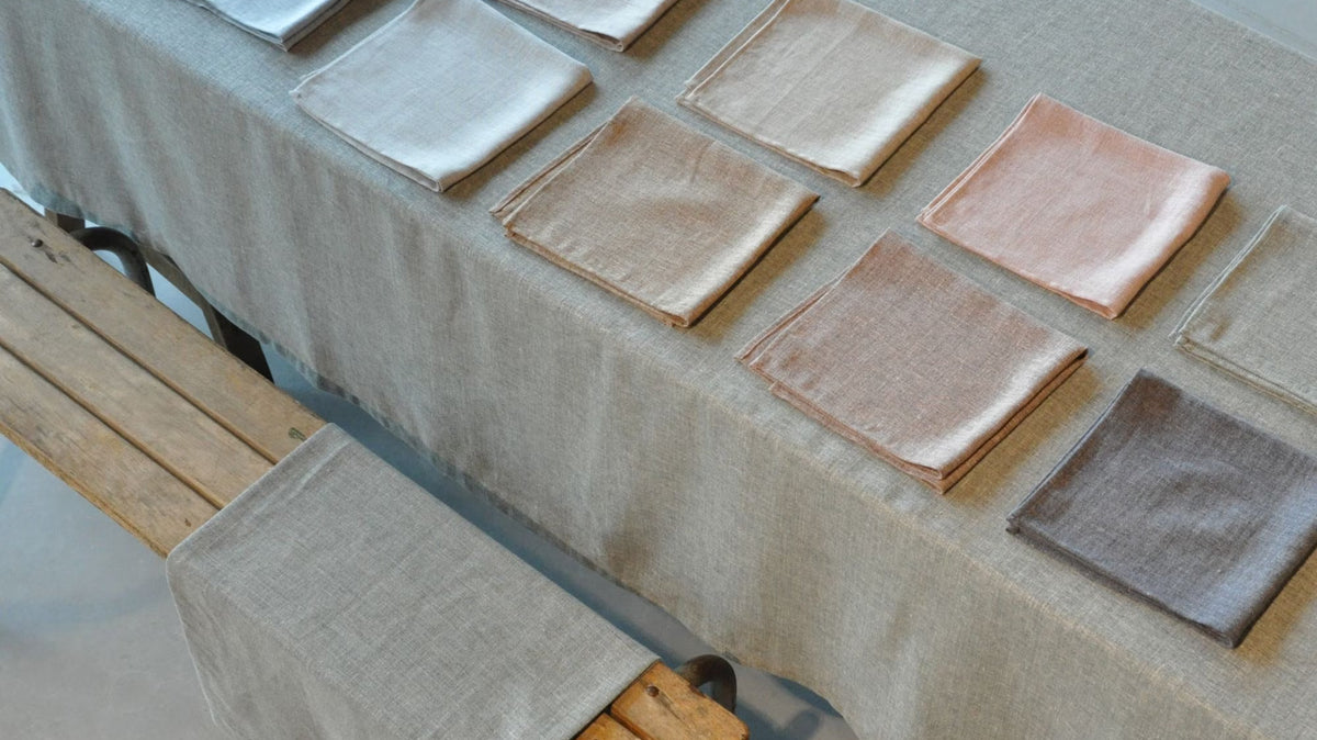 Libeco linen napkins laid out on a linen tablecloth